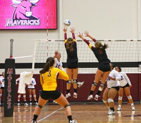 Megan Rush (left) looks on as Christian Otzen (middle) and Haleigh Higgins (right) attempt a block. - Photo: Michael Wong