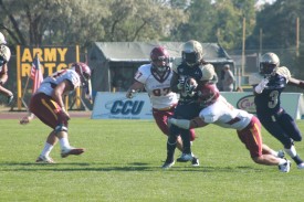 The CMU defense attempts to wrap up a runner on Saturday.
