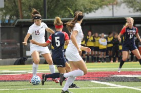 Freshman Taylor Bruno (#19) looks to pass the ball late in Sunday's game as the rain begins to fall. She had one shot on goal in 29 minutes played.