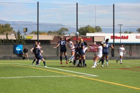 Redshirt sophomore Paige Denke leaps for a contested header in Sunday’s loss to Regis.