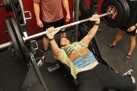 Clint Imlay pushes a loaded bar off of his chest during the bench press competition Wednesday.