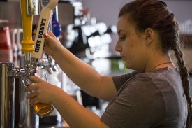 The Point employee Crystal Dumbleton, senior criminal justice major of San Diego, fills a pint glass with beer Thursday at The Point. Teams participating in Kegathon will be tasked with finishing 124 pint glasses of beer with a per-person maximum of two drinks per day.