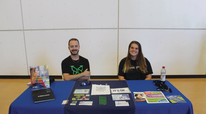 Members of CMU’s club softball team show off smiles at their table.