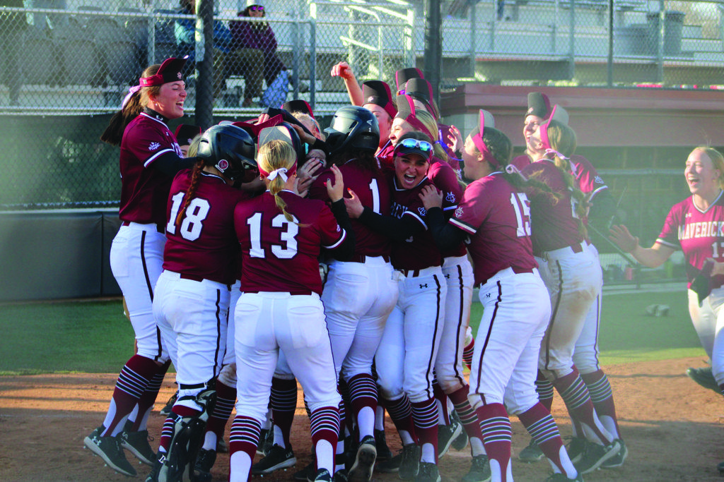 The softball team celebrates the walk-off homerun with their rally hats on after the game two win. 
\ Jordan Messler for The Criterion