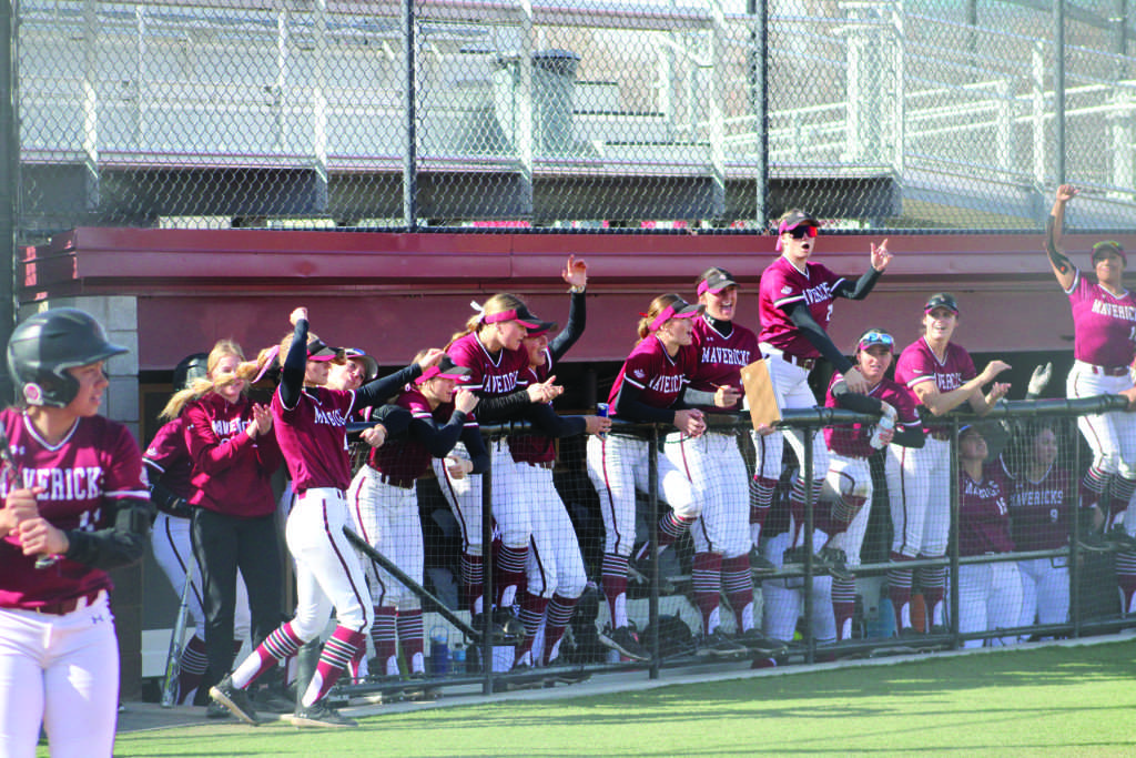 The Mavericks dugout, often led by pitcher Hannah Sattler, executing one of their chants for a teammate. 
The team leads the conference in multiple hitting statistics, in addition to improved pitching. 