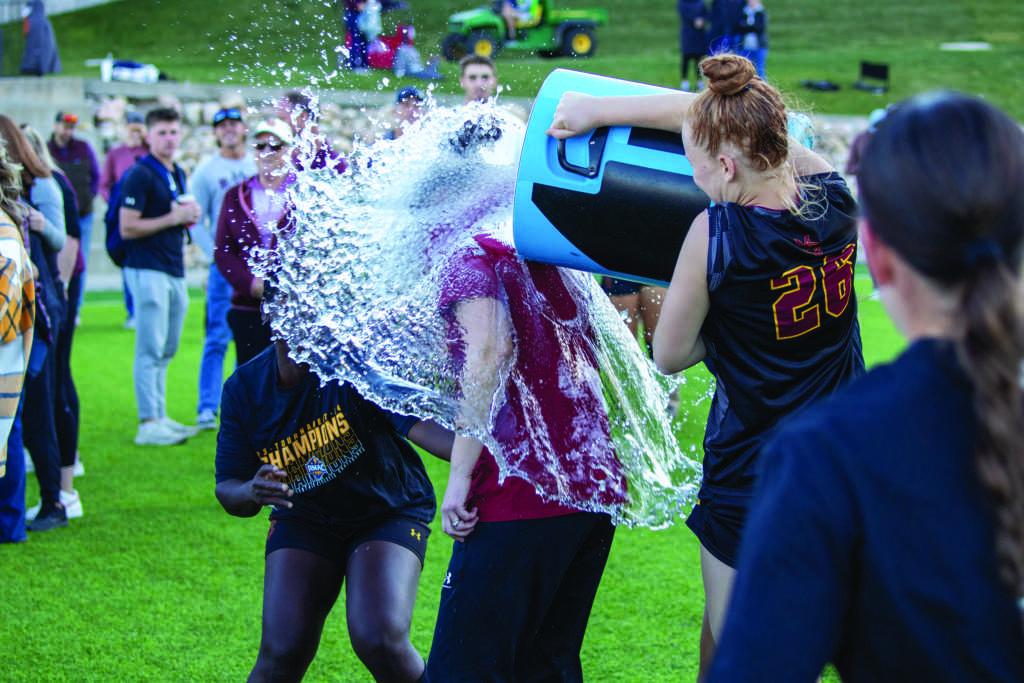 omen’s soccer head coach Megan Remec gets a water bath after winning the RMAC tournament championship.  