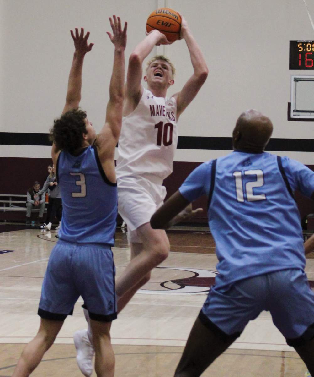 Redshirt  junior Ty Allred hitting a contested jump shot over a Colorado Christian University defender in a home contest. Allred is  averaging a team leading 14.9 points, 6.5 rebounds, and 1.6 rebounds per game. 
\\ Jordan Messler for The Criterion