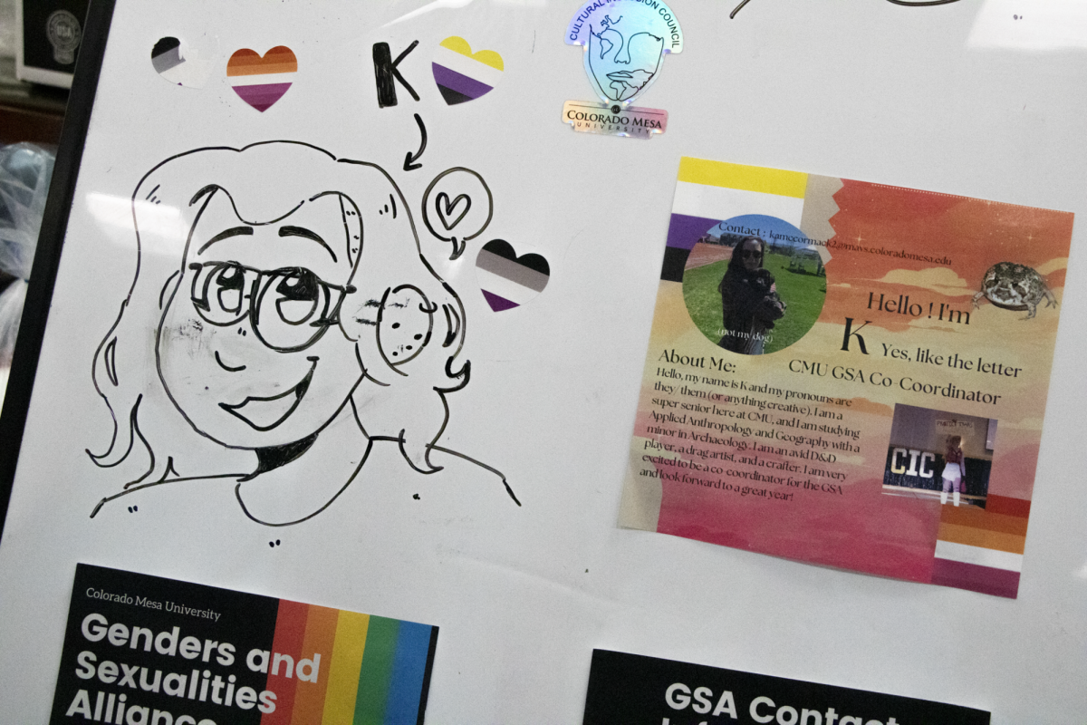GSA co-coordinator K McCormack featured on whiteboard in Student Life Office.