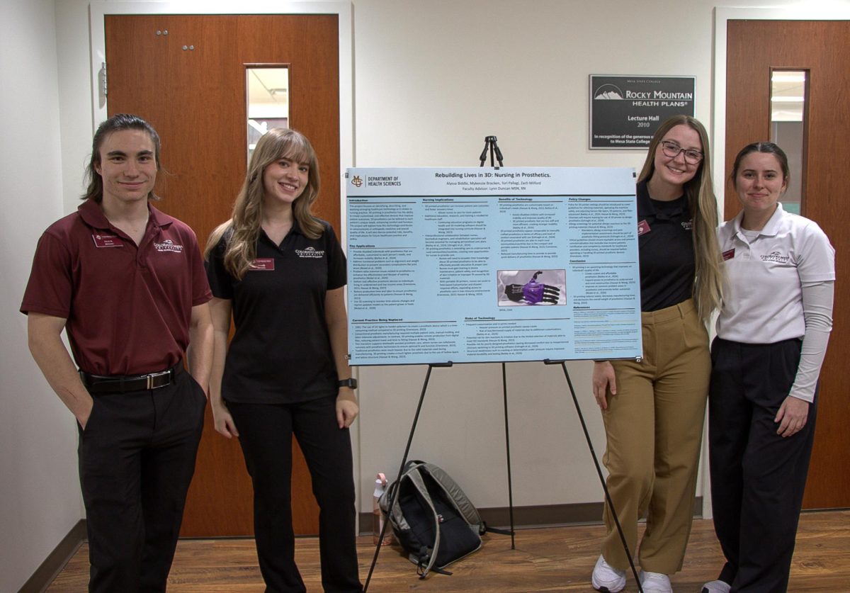 CMU nursing students (from left to right) Zach Milford, Tori Pallagi, Alyssa Biddle and Mykenzie Bracken stand in front of their research presentation poster about the significance of 3D-printed prosthetics.