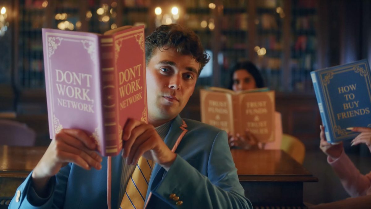 Three students of the fictional "Featherstone University" read books entitled "Don't Work. Network."