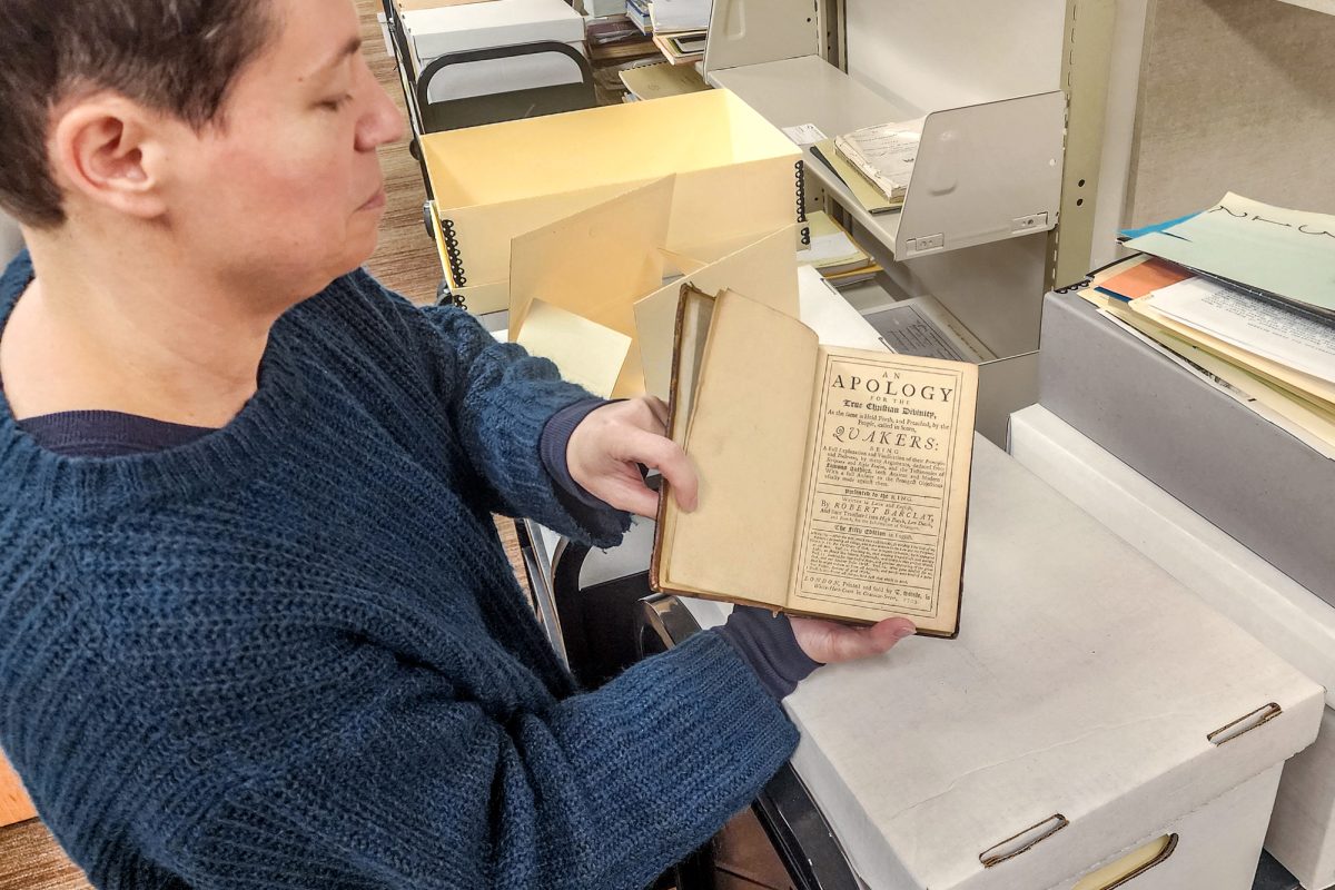 D'Ambrosio flips open a copy of "An Apology for the True Christian Divinity" by Robert Barclay, which outlines the principles associated with the Quaker Movement.