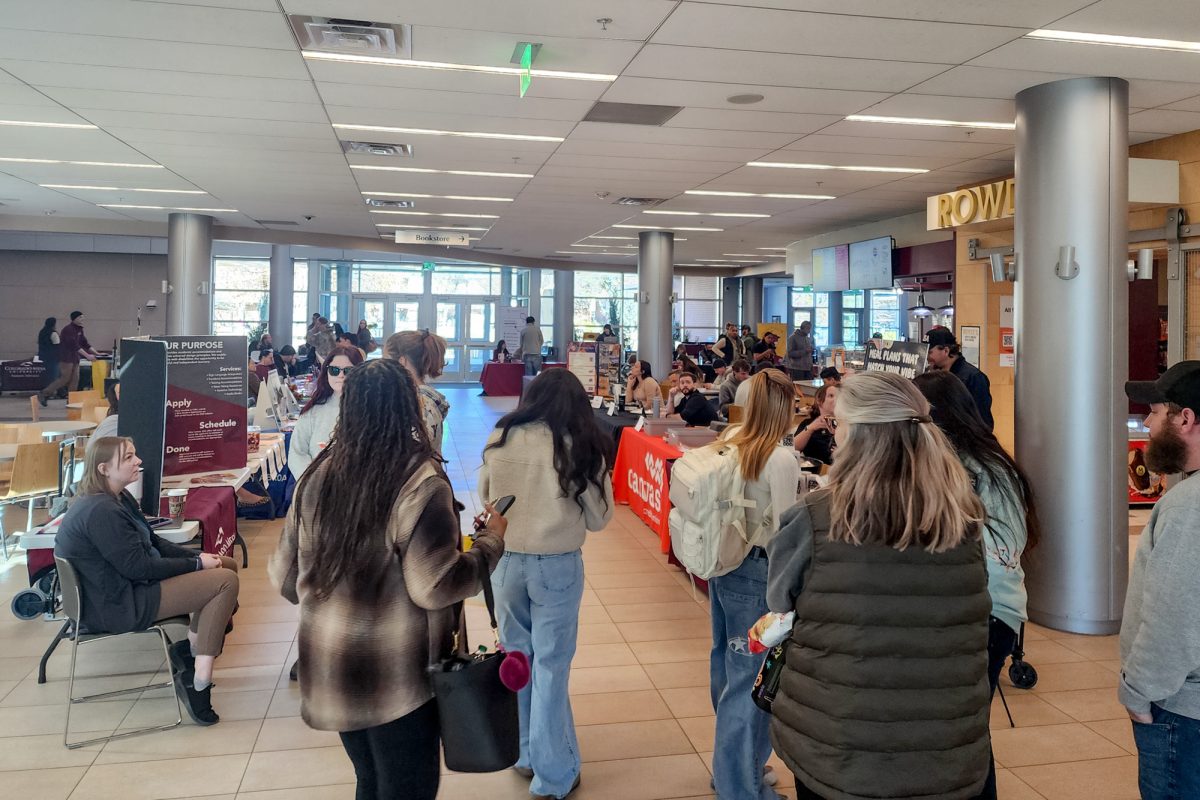  Attendees queue up to learn more about the groups tabling at the Taking Care of Business Fair. Dozens of tables and hundreds of students filled the first floor of the University Center. 