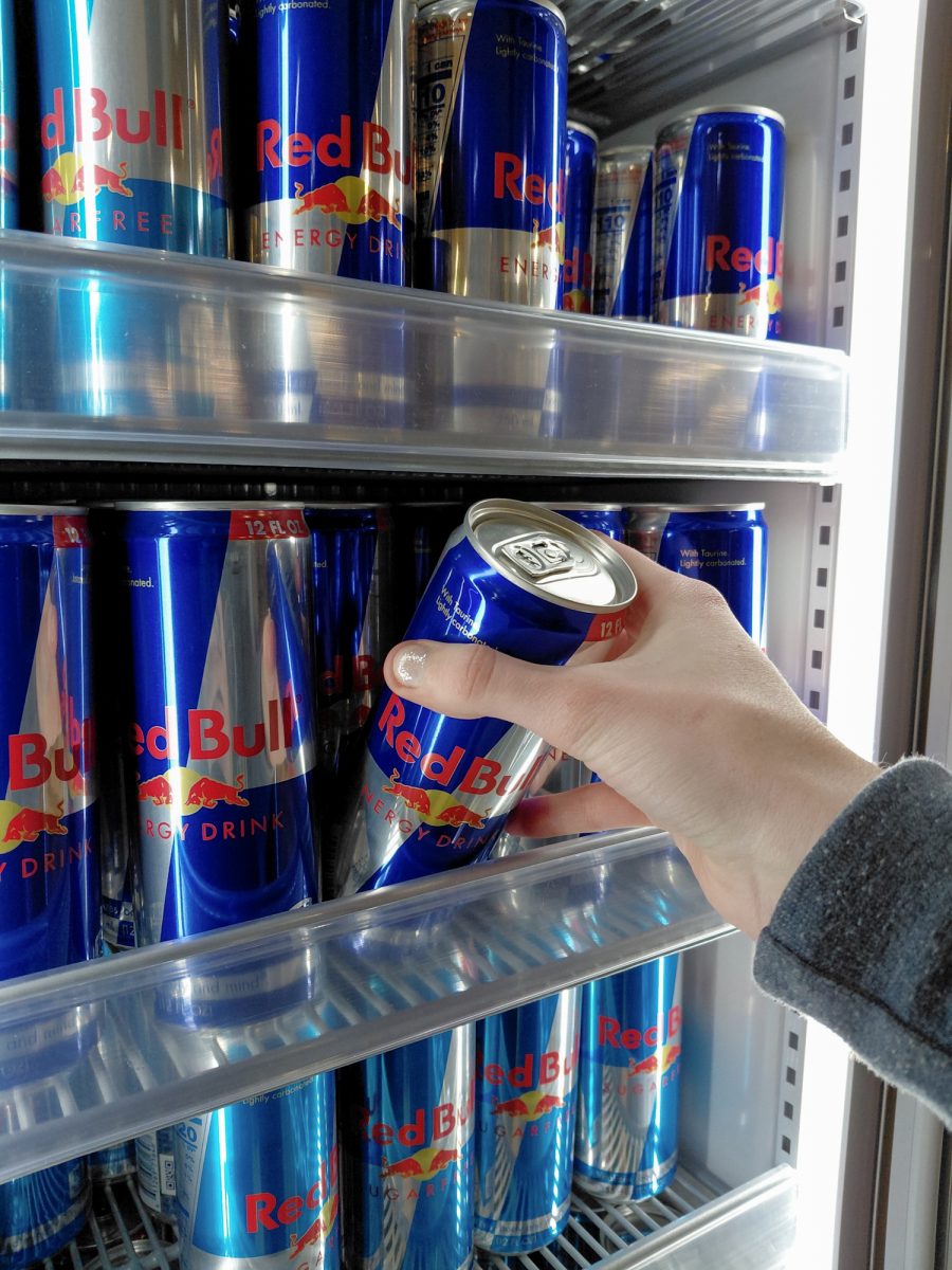 A student pulls a can of Red Bull from the new Red Bull fridge recently installed at Rowdy’s. CMU changed their drink sponsor from Coke to Pepsi during winter break.