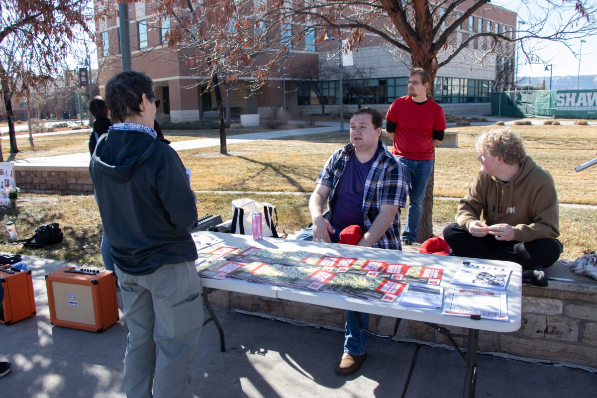 The CMU chapter of the Young Democratic Socialists of America (YDSA-CMU) co-chair Nikoli Weir engages with a community member about the club’s campaign to get CMU designated as a sanctuary campus. YDSA-CMU hosted a vigil to honor the victims of ICE killings on Feb. 14.