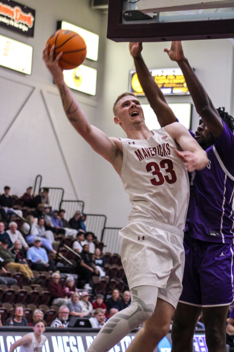 Junior forward Clayton Jewell (33) charges the Brownson Arena basket against New Mexico Highlands in the RMAC quarterfinal. The Mavericks won 91-90 in overtime. They traveled to Spearfish, South Dakota and took second in the RMAC.