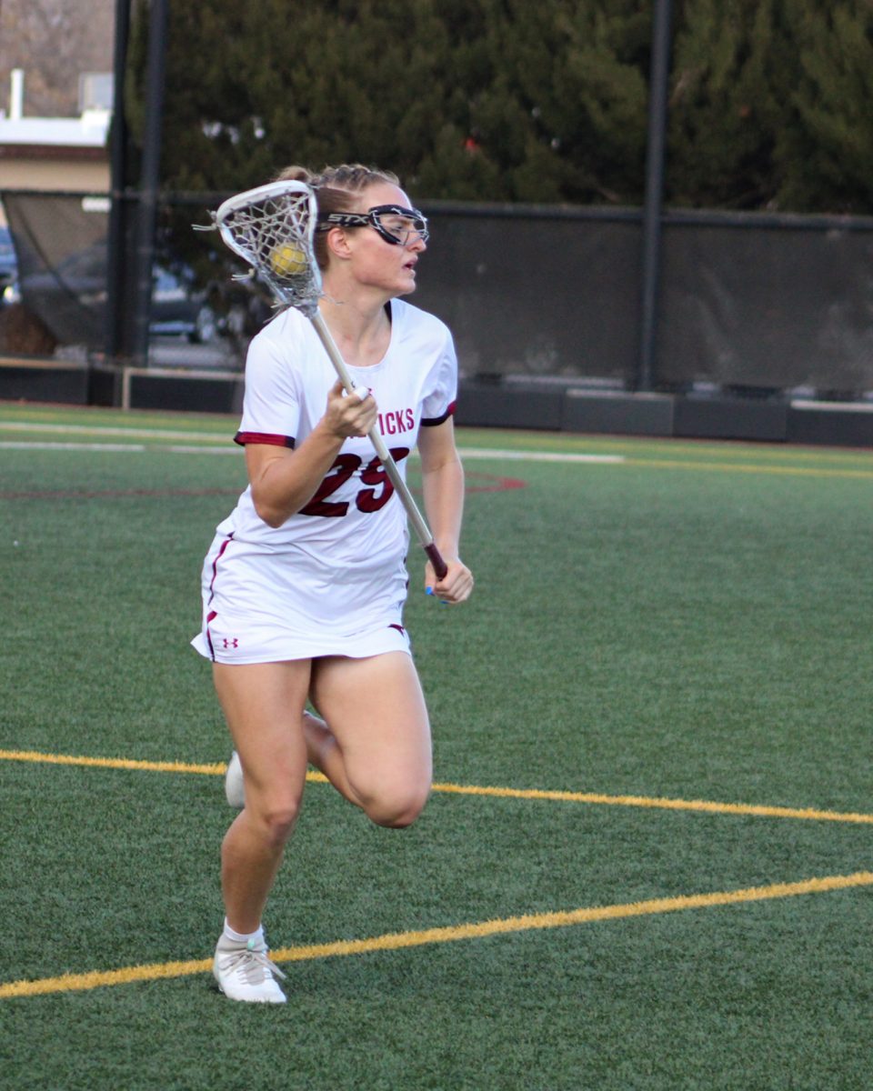 Junior defender Monroe McClimans (29) breaks away against Northern Michigan University. Women’s lacrosse switched to Nike as their uniform provider, allowing players to wear shorts over skirts.