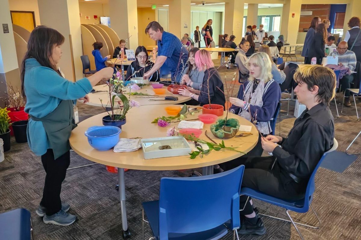Sophomore anthropology major Lance Glauer and Ferguson participate in a flower arranging workshop. Ikebana is a specific style of arranging that focuses on assymetry and minimalism. (Courtesy of Zach McCay)