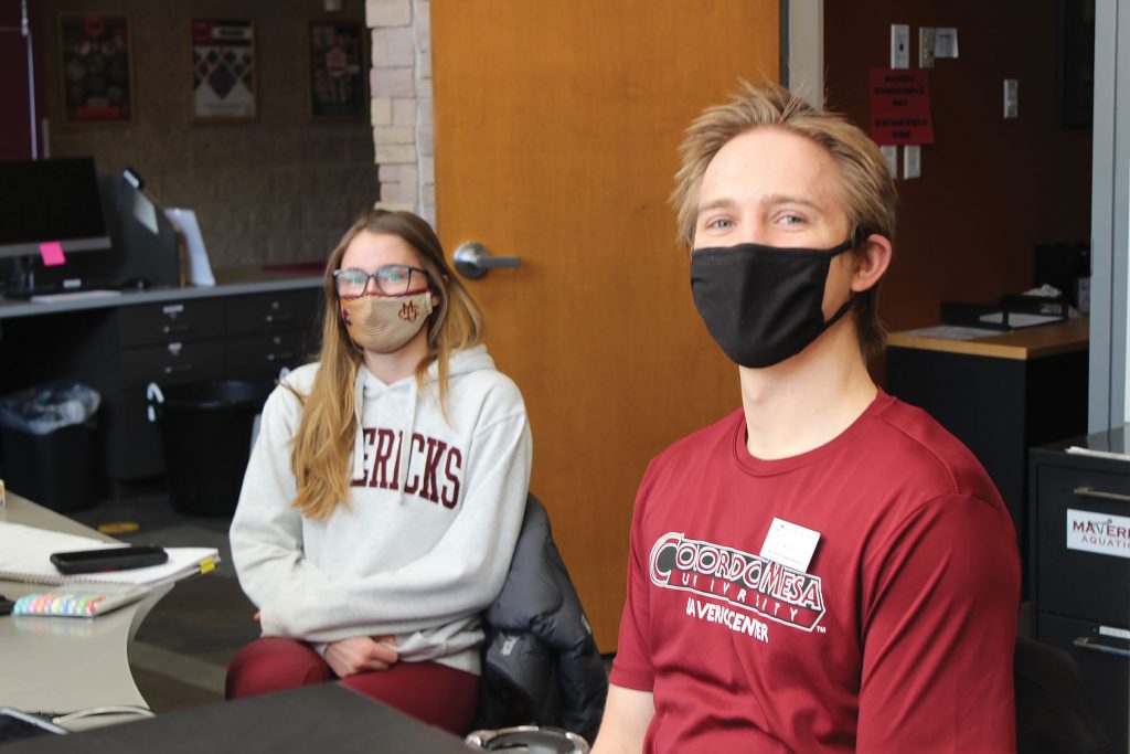 Coworkers at the Gym, Micah Hightower and Kami Thompson run the front desk.