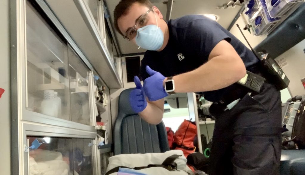 EMT Ryan Chamberlain poses inside ambulance